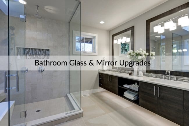 Modern style bathroom with a glass shower to the left and two sinks to the right. Also has a banner that says,"Bathroom Glass & Mirror Upgrades."