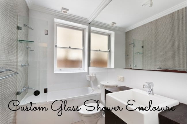 very modernized bright-white bathroom with a window behind the shower