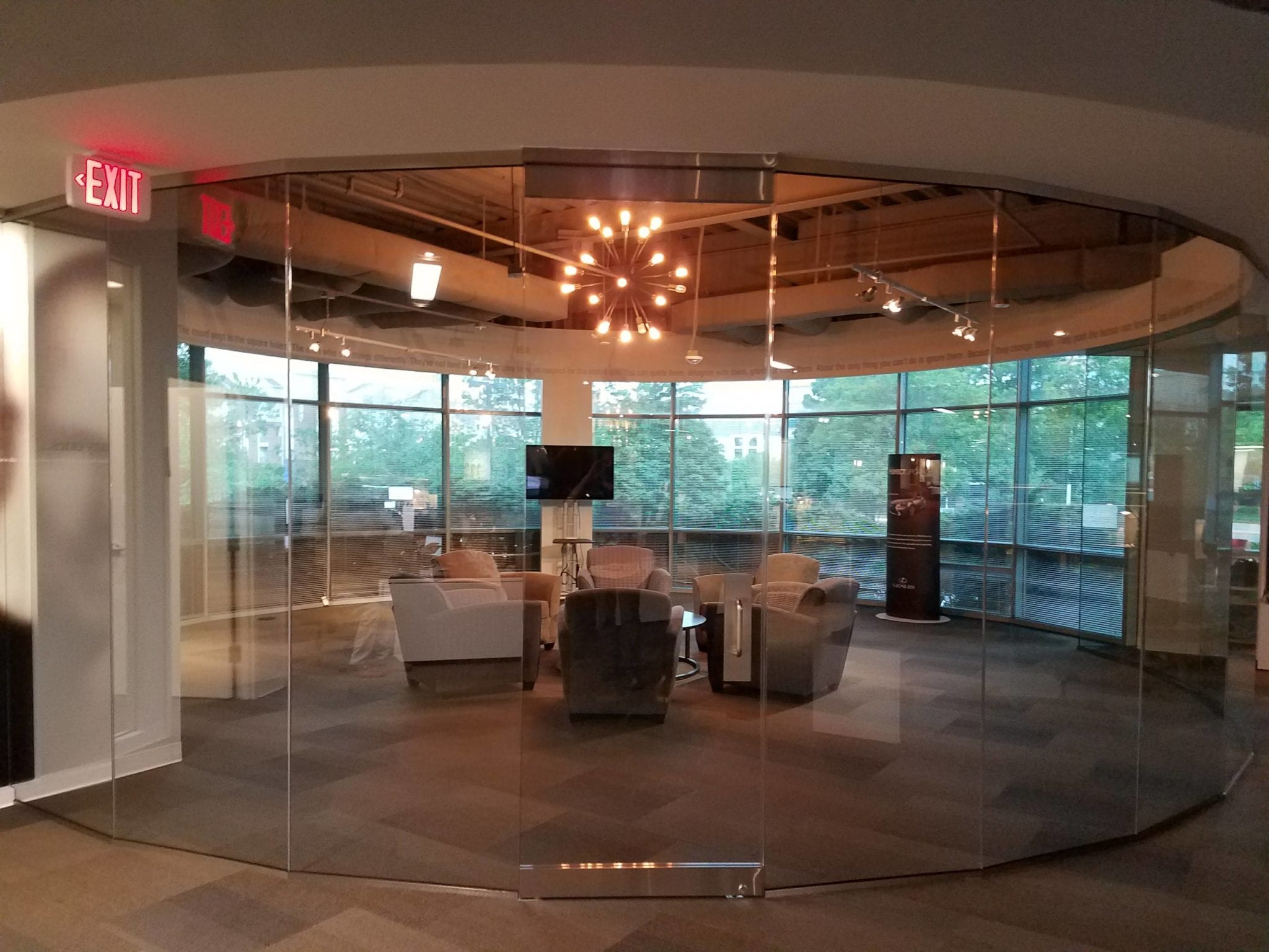 meeting room with five chairs in the center and glass all around as walls