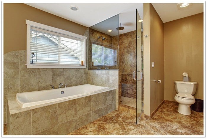 bathroom with a tub to the left, a frameless glass shower in the middle, and a toilet to the right