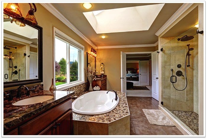 beautiful bathroom with modern sink and bathtub to the left and a frameless glass shower to the right