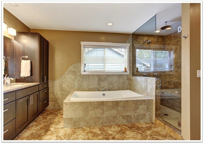 modern bathtub in the center of photo with a walk-in frameless glass shower to the right