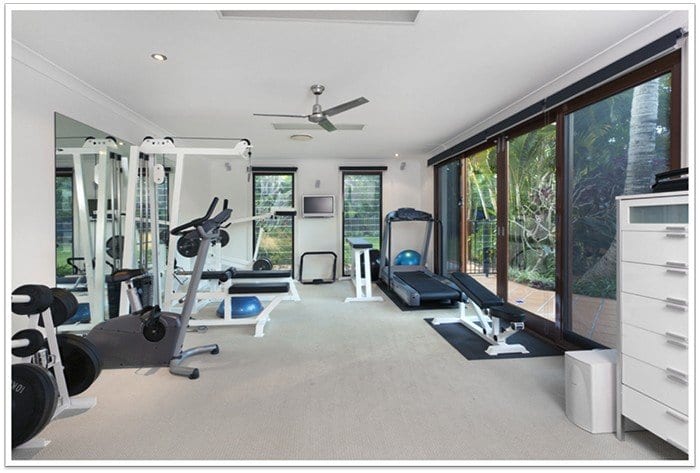 home gym with mirrors and sliding glass doors