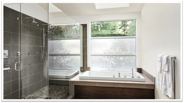 white bathtub in-front of a shower and window