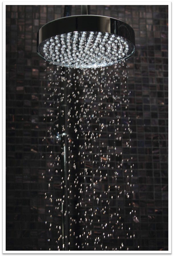 shower head with an LED light in it shining down on falling water