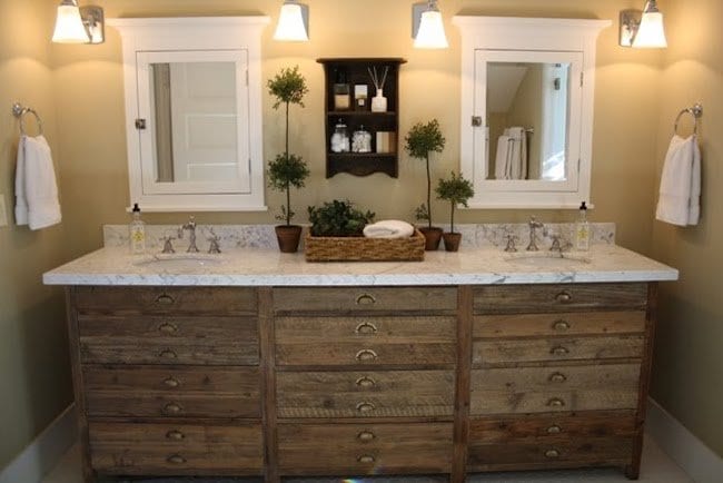 Two modern sinks, side by side with mirrors next to them.