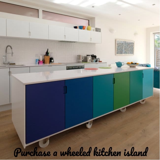 kitchen with color cabinets in the front and white cabinets above a sink in the back