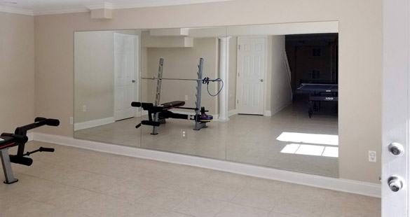 Example of glass gym mirror with floor trim.