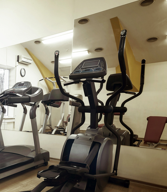 Two glass gym wall mirrors in a home gym.