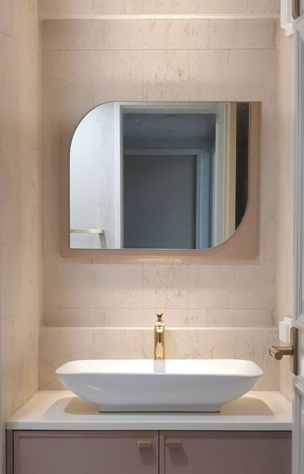 Unusual mirror shape above sink