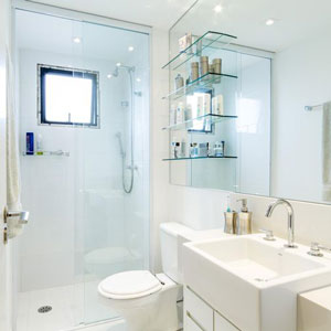 Replace a shower curtain or patterned glass door with a clear glass enclosure.