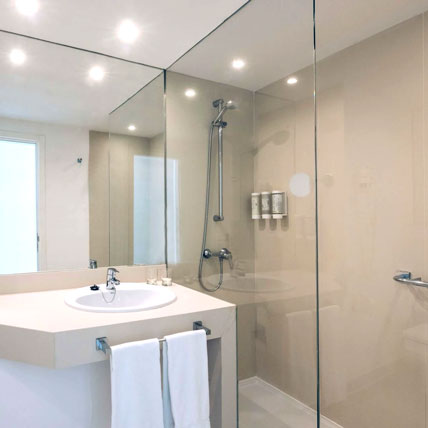 Consider a shower screen. Depending on your shower and bathroom, you may not need to fully enclose the shower entrance with glass.