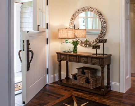 Round framed mirror in a foyer