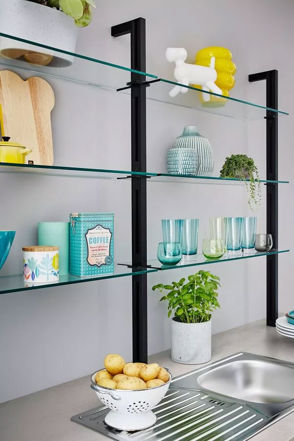 Glass shelves above kitchen sink