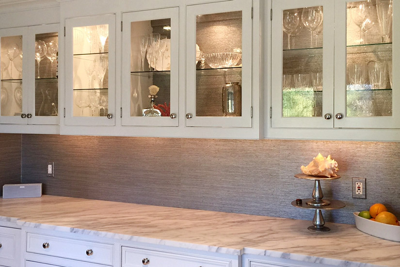 Cream colored shelves with glass front panels