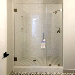 A glass shower enclosure is more pleasant and user friendly.