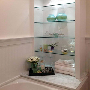 Get creative about creating storage options – glass shelves above the toilet, a corner cabinet, a hanging basket, a row of robe hooks, etc.