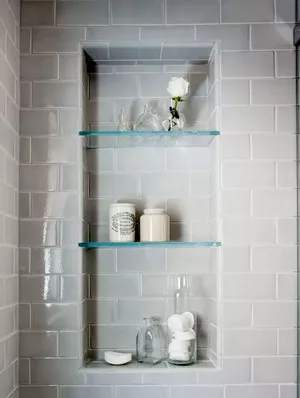 Glass shelves can be used to organize items in a small bathroom