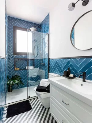 A blue and white palette paired with a few beachy pieces gives your bathroom a coastal vibe.