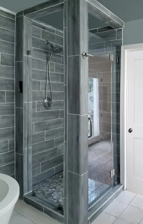 Metals in the silver family can be used to bring a cool and calming feel to a space. These can enhance an effect already created by a gray palette, a sleek frameless glass shower, smooth surfaces, and clean lines. 