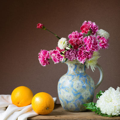 Nature based decor can include jugs of cut flowers, natural wood cutting boards, stone elements, and plants potted in old-fashioned planters.