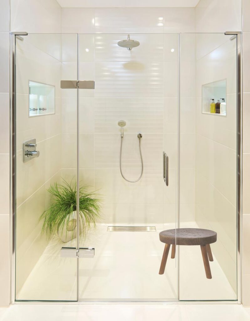 When arranging items on your shower’s glass shelves, stool, or niche, keep in mind that odd numbered groupings are more pleasing to the eye than even. It’s also nice to vary heights and textures within a single display when possible.