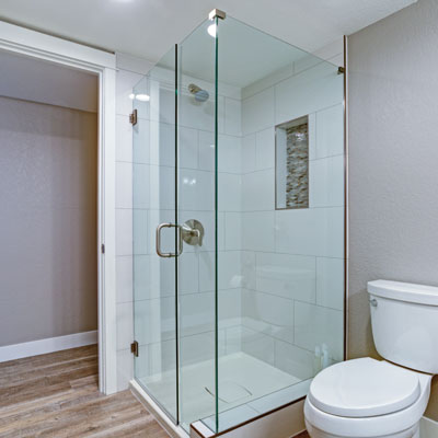 Walls that are neutral or a pale pastel can work in harmony with a glass shower to make a tight space feel more airy and open.