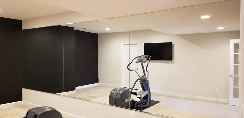 The term “gym wall mirror” refers to one or more large mirrors installed on a wall in a space used for fitness related activities. 