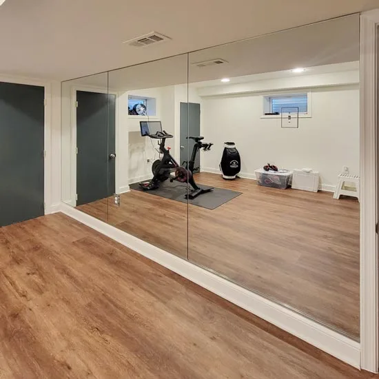 Custom glass shops like ABC can cut small voids in mirrors so that they fit around existing fixtures and obstructions.