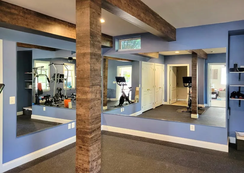 Gym wall mirrors improve the functionality of your space, but they also boost its aesthetics. If the room also has a window, you should have the mirrors installed on a wall perpendicular to the window to maximize natural lighting.