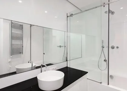 A piece of back painted glass can also be added to the vanity top in a bathroom.