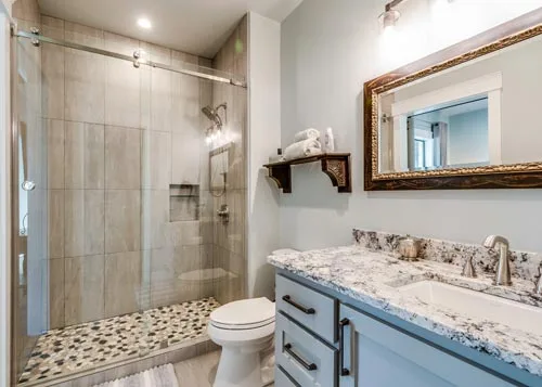 Bathroom with a shower, vanity and toilet designed with a spa vibe.